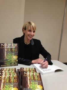 Marti MacGibbon signed copies of her award-winning memoir, Never Give in to Fear
